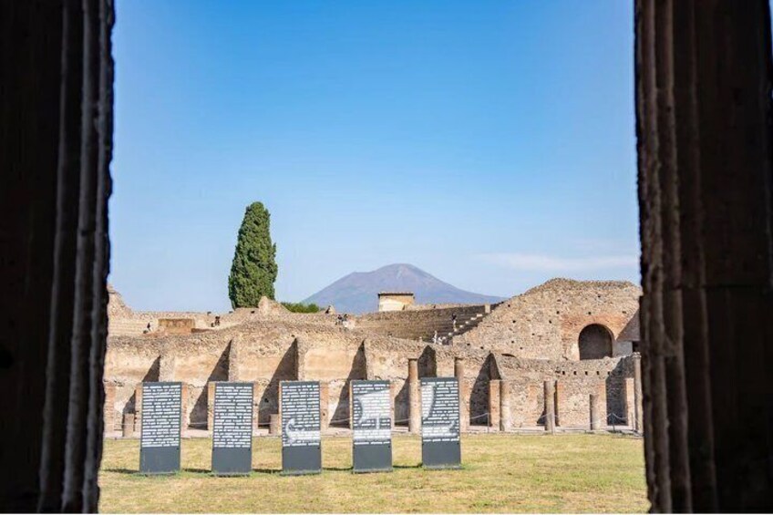 Ancient ruins with stone columns and a mountain in the background. 5