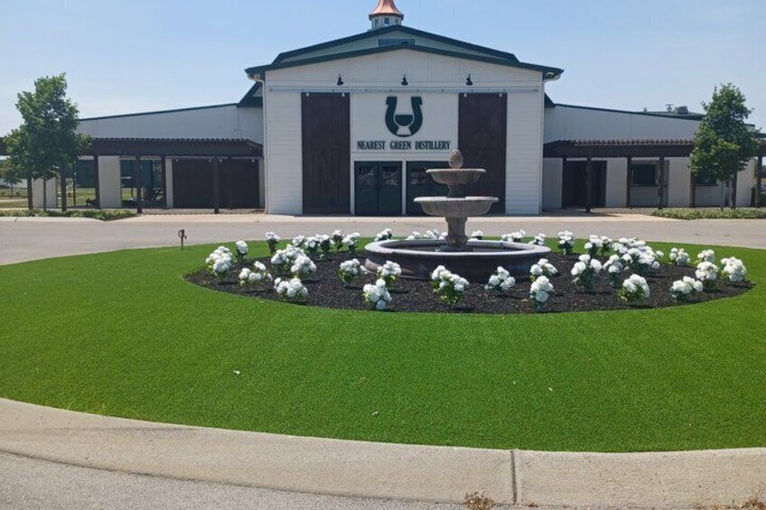 A building with a horse logo and the name 'Nearest Green Distillery.' 1