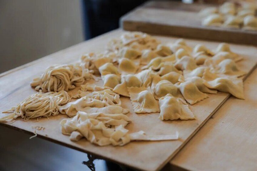 A table with dumplings and noodles. 3