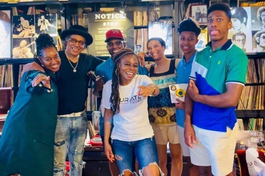 A group of people in a bookstore with bookshelves and a 'NOTICE' sign. 5