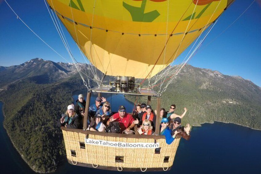 A hot air balloon with passengers over a mountainous landscape. 5