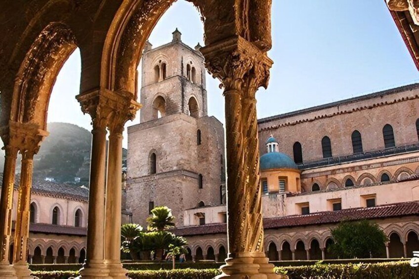 A historic building with arches and a bell tower. 4