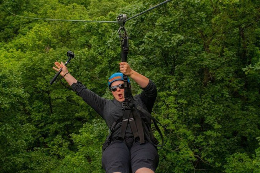 A person zip-lining through a forest. 5