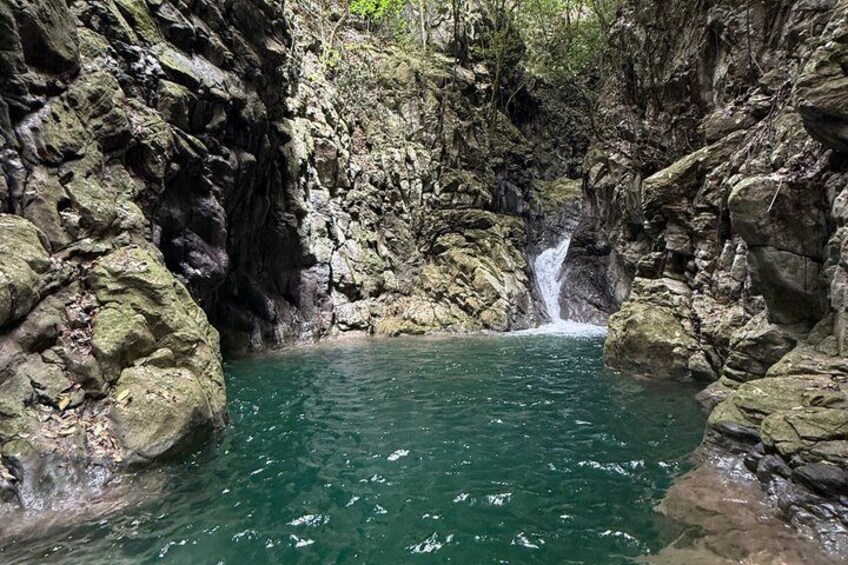 A natural rock pool with a waterfall. 5