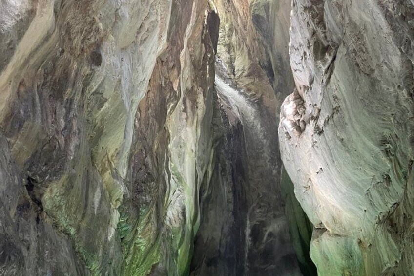 A rock formation with layered textures and colors. 1