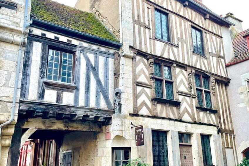 A half-timbered building with a steeply pitched roof and a small dormer window. 5
