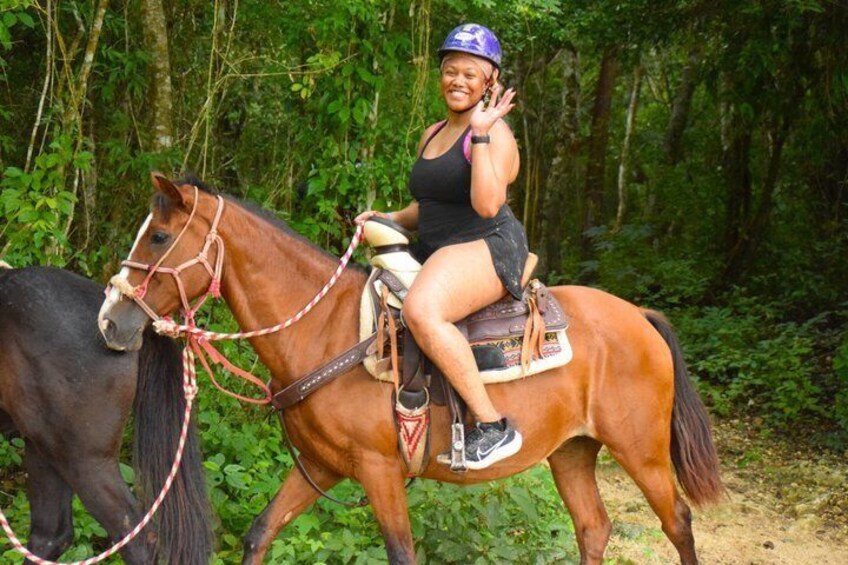 A person riding a horse through a forested area. 2