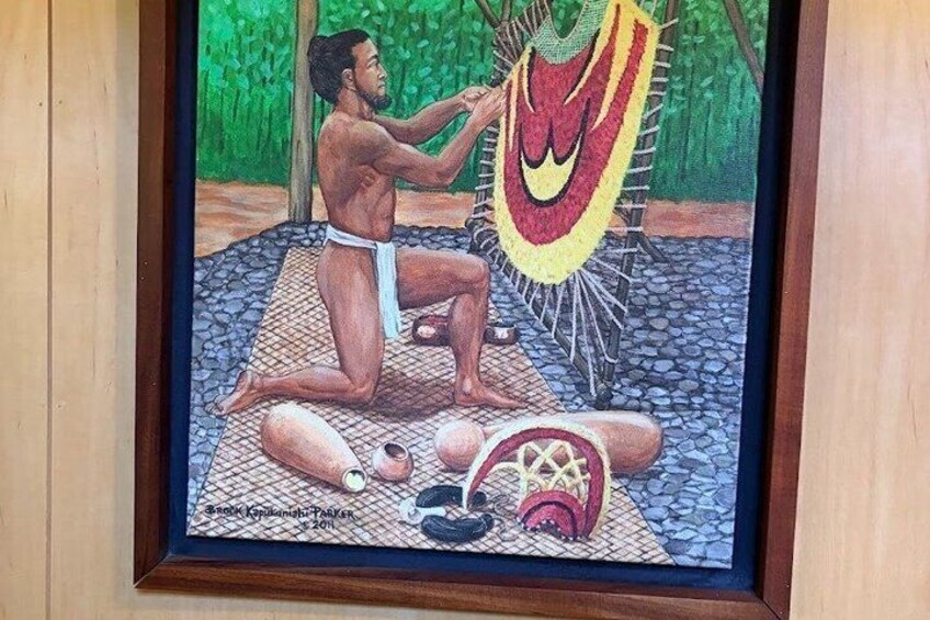 A person in traditional attire performing a ritual with a hammock and ritualistic objects on a stone-paved area. 3
