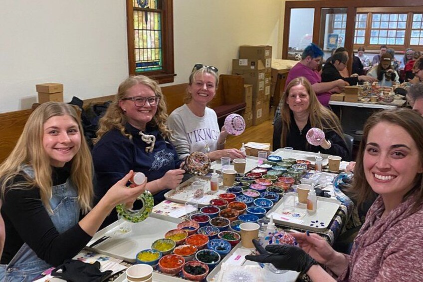 A group of people at a table with bowls of colorful food and drinks. 5