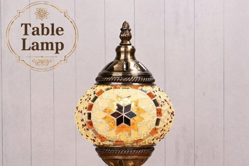 A table lamp with a decorative base and a mosaic-patterned lampshade. 2