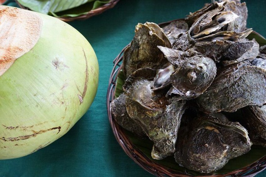 A green coconut and a basket of dried coconuts. 5
