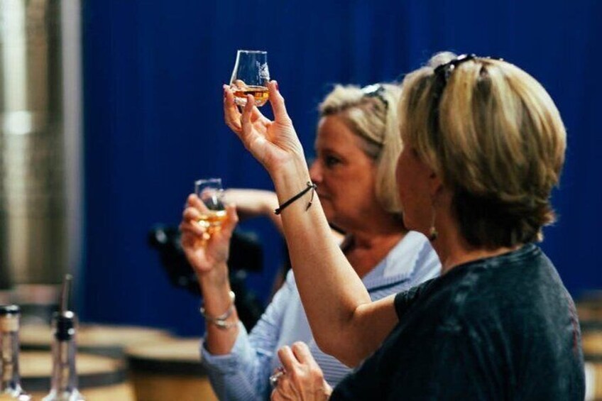 A person holding a glass with a drink. 3