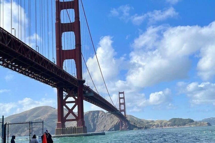 The Golden Gate Bridge spanning a body of water with hills in the background. 4