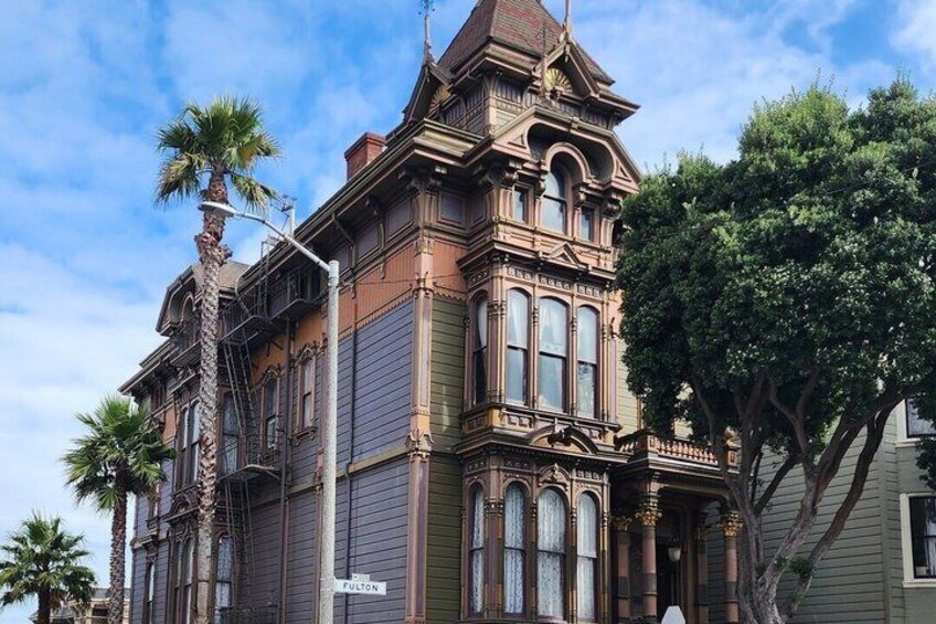 A Victorian-style building with ornate detailing and a prominent tower. 5
