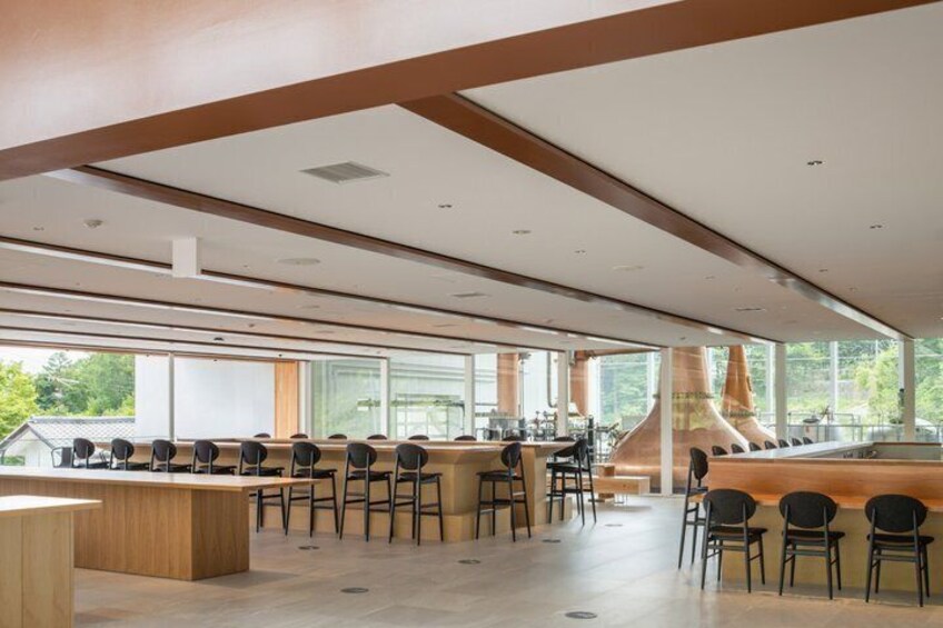 A modern kitchen with a long counter, bar stools, and a large stove. 3