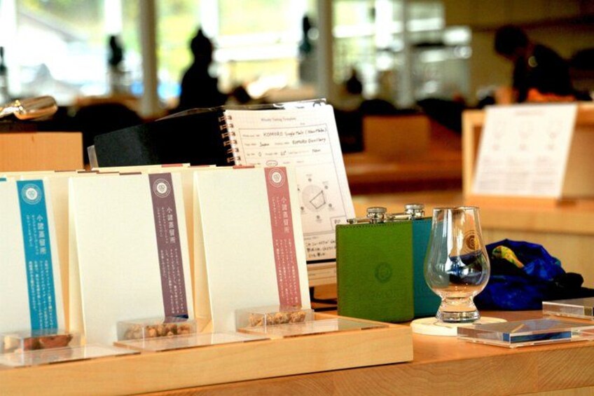 A book display with a glass of water and a notebook on a wooden table. 2