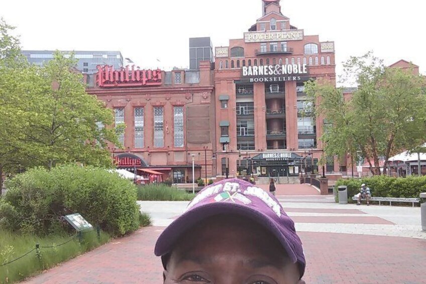 A brick building with 'Barnes & Noble Booksellers' signage, a red awning, and a pathway leading to it. 4
