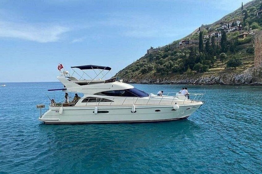 A white yacht on calm waters with a hilly landscape in the background. 1