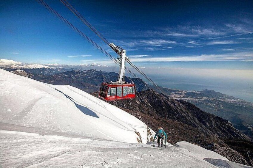 A ski lift chair on a snowy mountain slope with a clear sky. 2