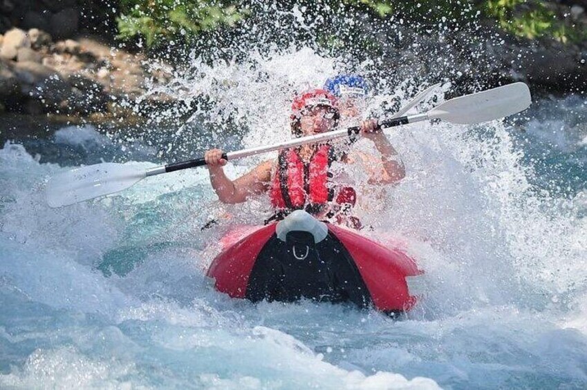 A person kayaking on a river. 5