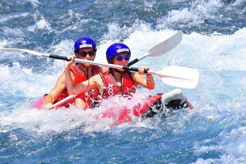 Two people kayaking on a river. 2
