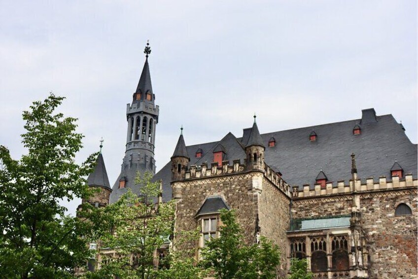 A historic building with a prominent tower and multiple spires. 2