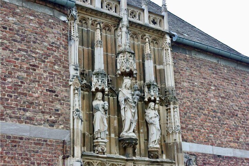 A Gothic-style window with intricate stone carvings and statues. 4