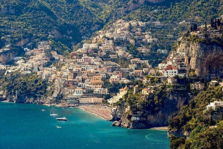 A coastal town with buildings built on steep cliffs overlooking the sea. 4
