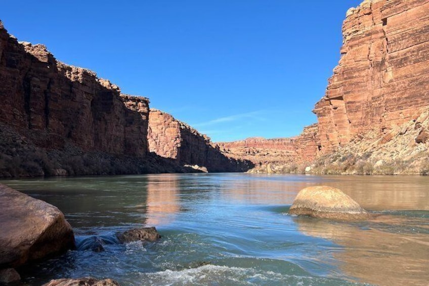 A river flowing through a canyon with red rock walls. 5