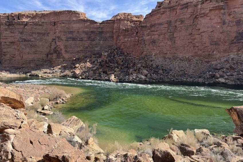 A river flowing through a canyon with rocky terrain and cliffs. 3