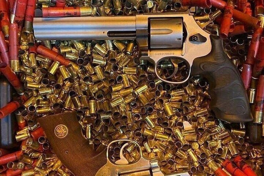 A revolver surrounded by numerous bullets. 3