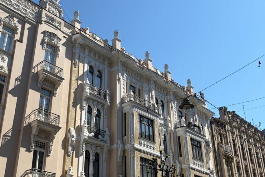 A row of ornate, historic buildings with intricate facades and balconies. 3