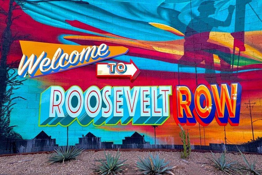 A colorful mural with the text 'Welcome to Roosevelt Row' and a silhouette of a person skateboarding. 2