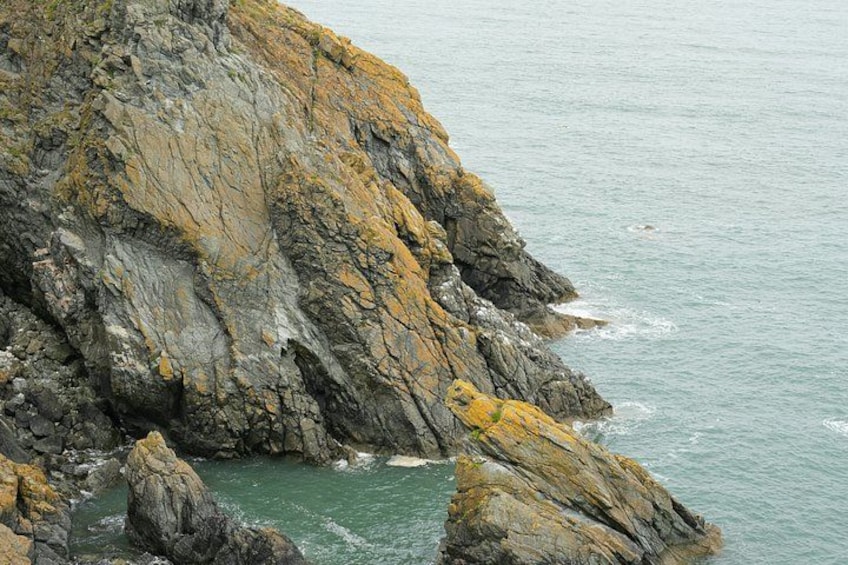 A rocky coastline with waves crashing against the shore. 4
