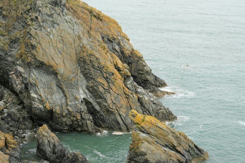A rocky coastline with waves crashing against the shore. 4