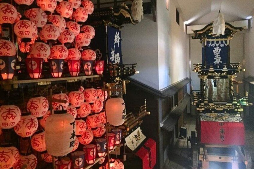 A traditional Japanese shrine with lanterns and a ceremonial altar. 5
