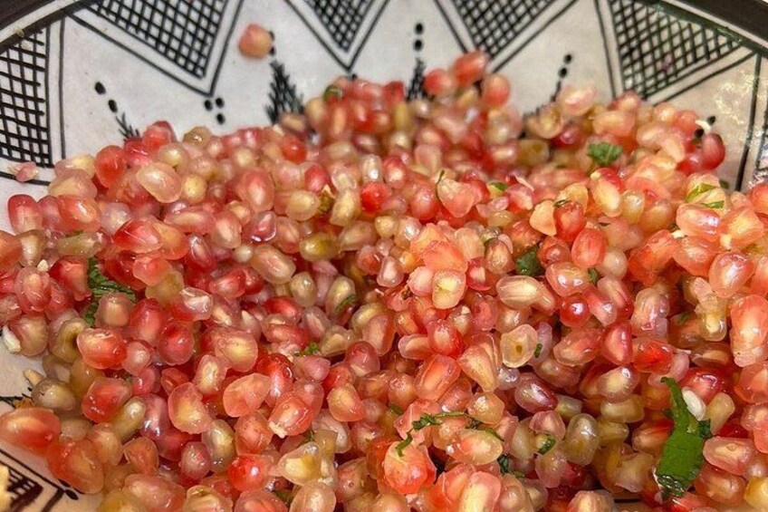 A bowl of mixed grains, possibly a salad, with a patterned bowl in the background. 4