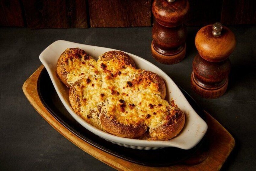 A dish of garlic bread on a white oval plate. 5