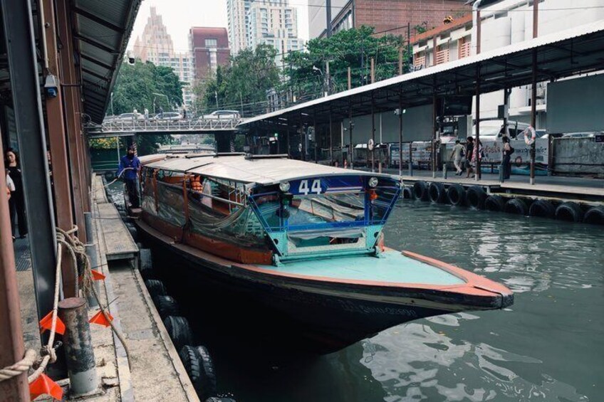 A boat docked at a pier with a cityscape in the background. 4