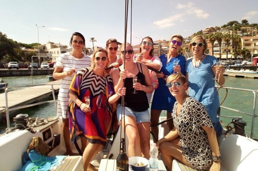 A group of people on a boat near a marina with buildings and parked cars in the background. 3