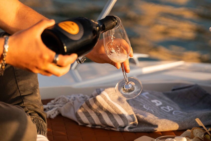 A person pouring champagne into a glass. 4