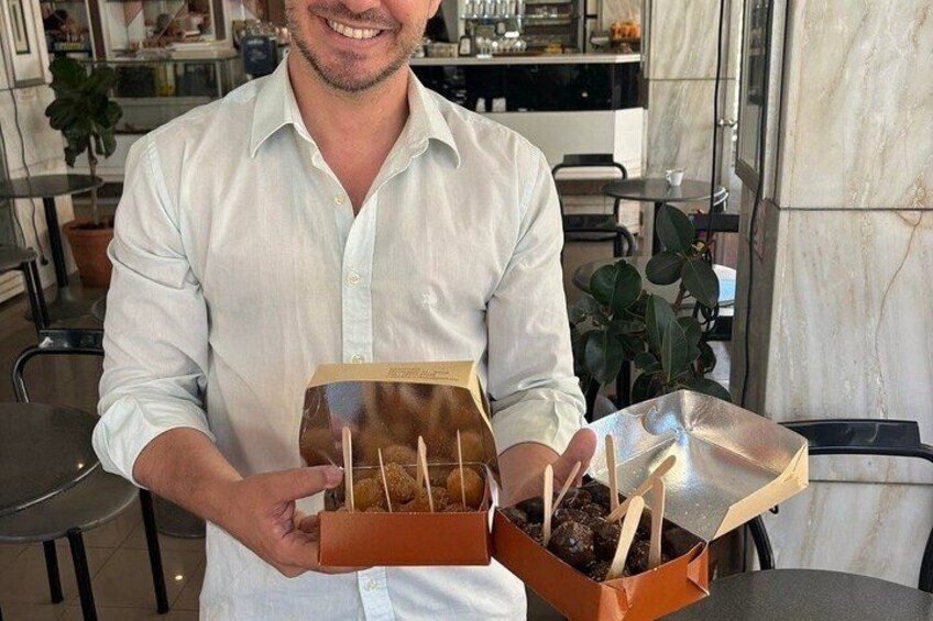 A person holding a box with a plant and sticks. 5