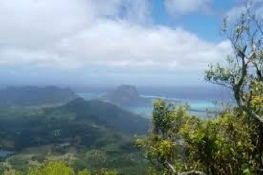 A coastal landscape with mountains, a body of water, and a clear sky. 3