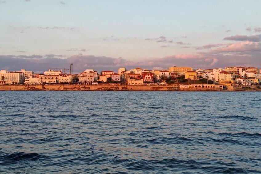 A coastal cityscape with buildings along the waterfront. 3