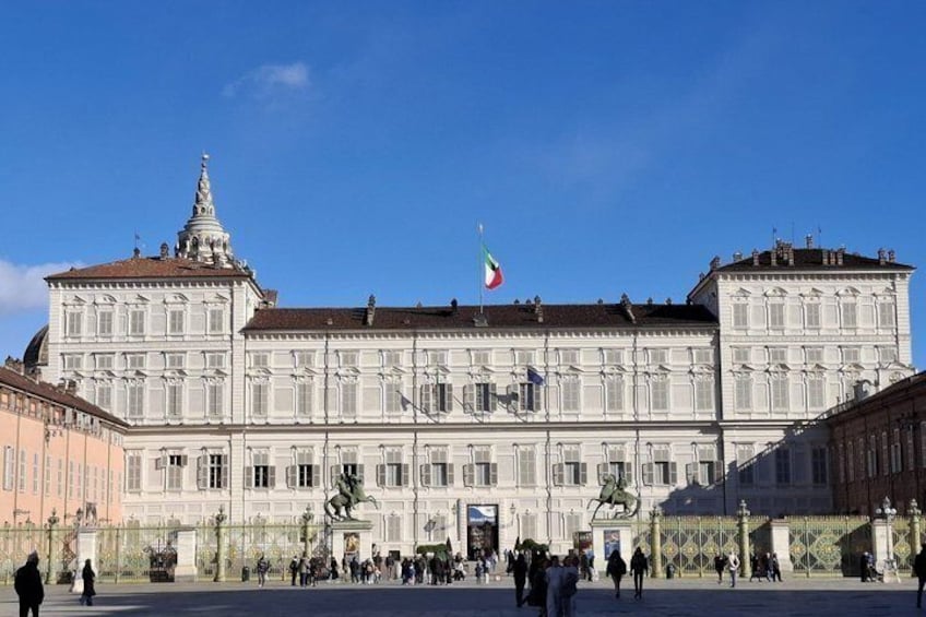 A large historic building with a prominent dome and flag. 3
