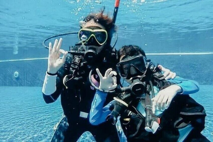 Two people scuba diving underwater. 5