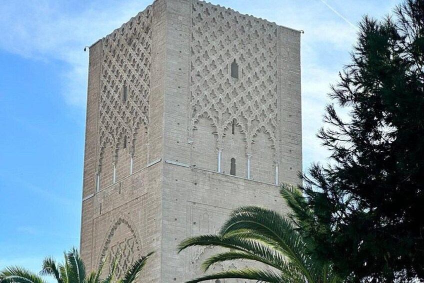 A tall, intricately designed tower with lattice patterns and arched windows. 2