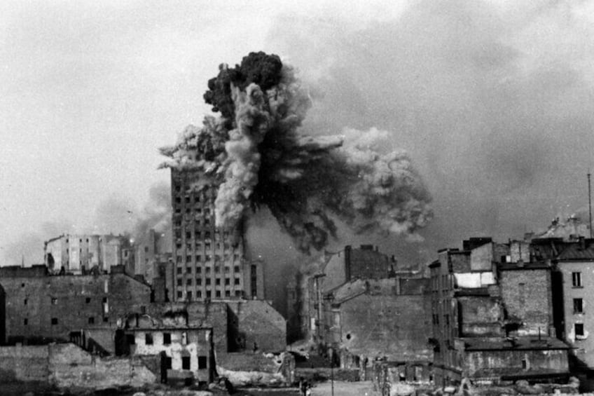 A cityscape with a tall building emitting thick smoke. 4