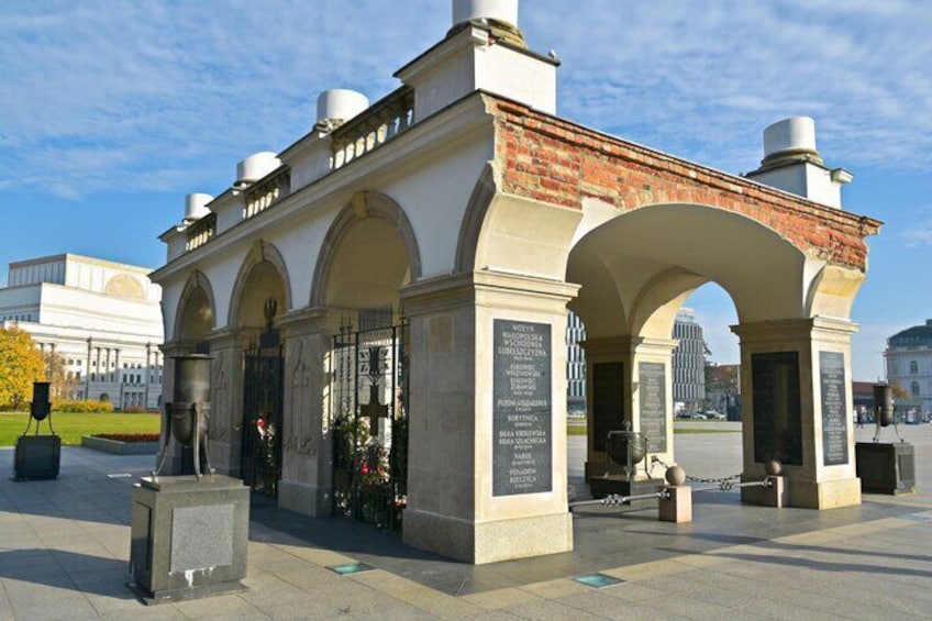 A historical monument with inscriptions, arched structures, and a brick roof. 5