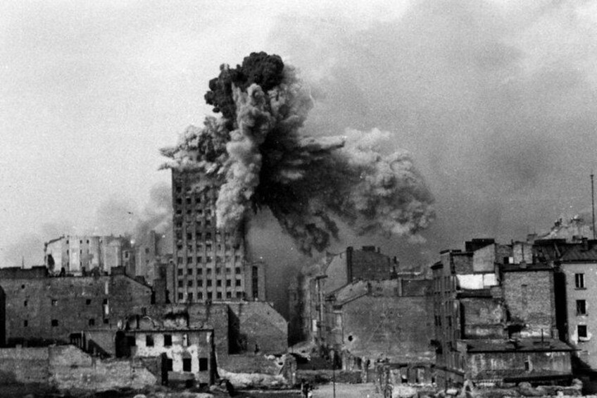 A cityscape with a large building emitting thick smoke. 2
